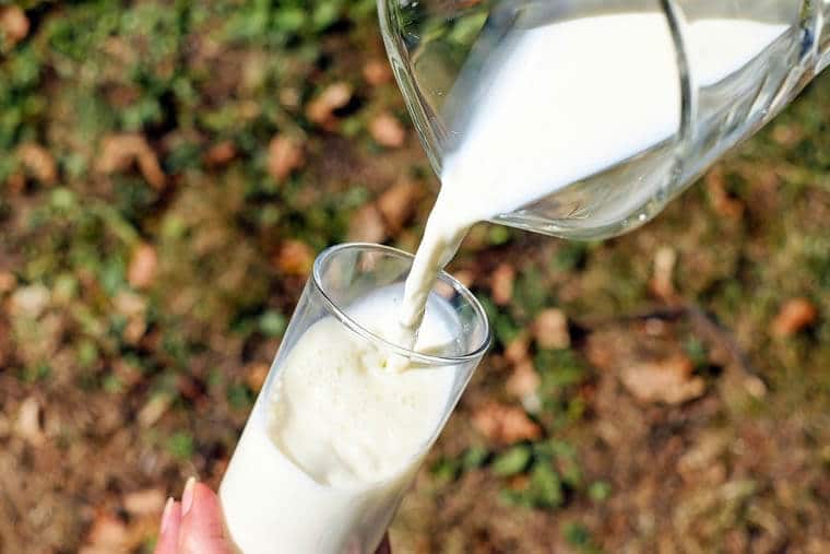 Milk being poured into a cup.