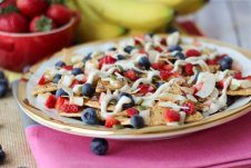 A close up of a plate of cheesecake flavoured nachos.