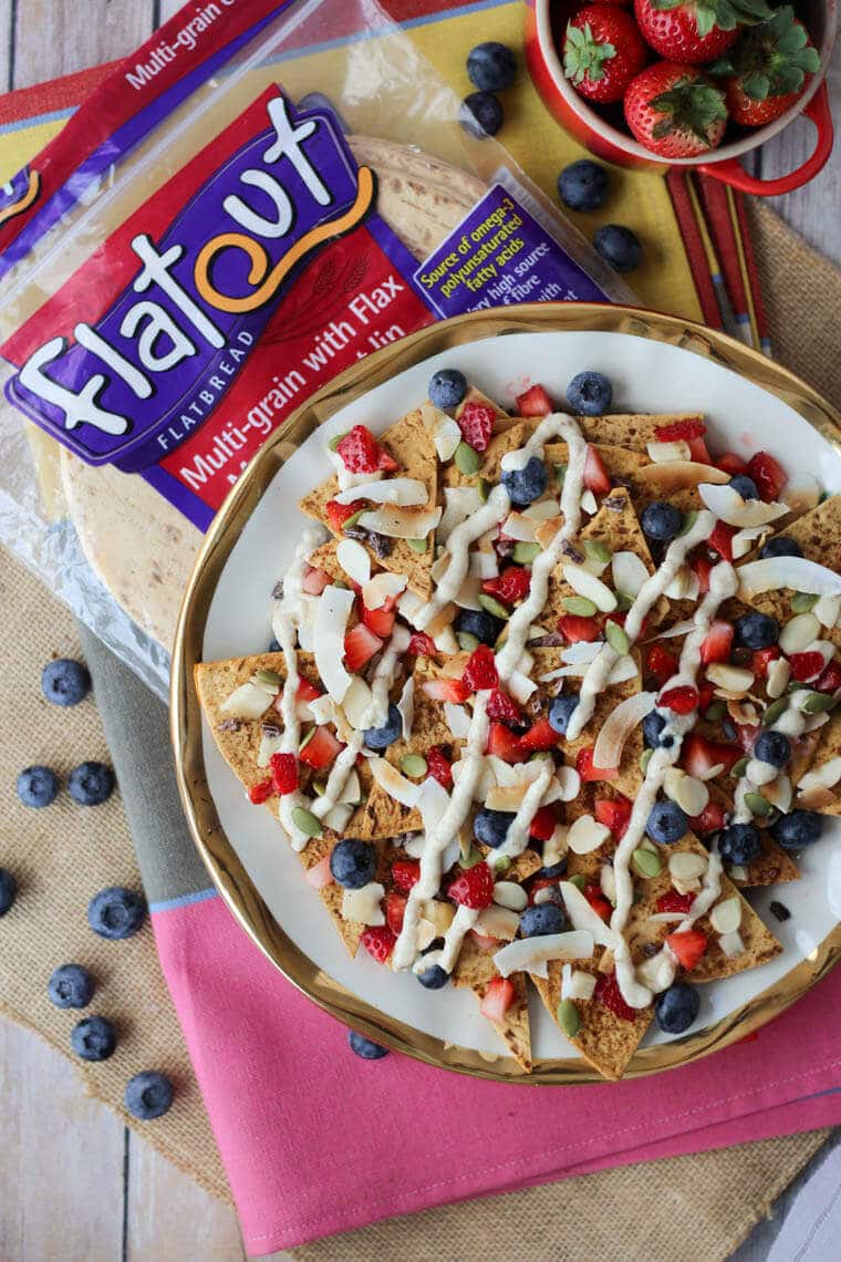 An overhead photo of a plate of dessert nachos with a bag of flatout flatbread behind it.