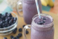 Two glasses of blueberry smoothies.