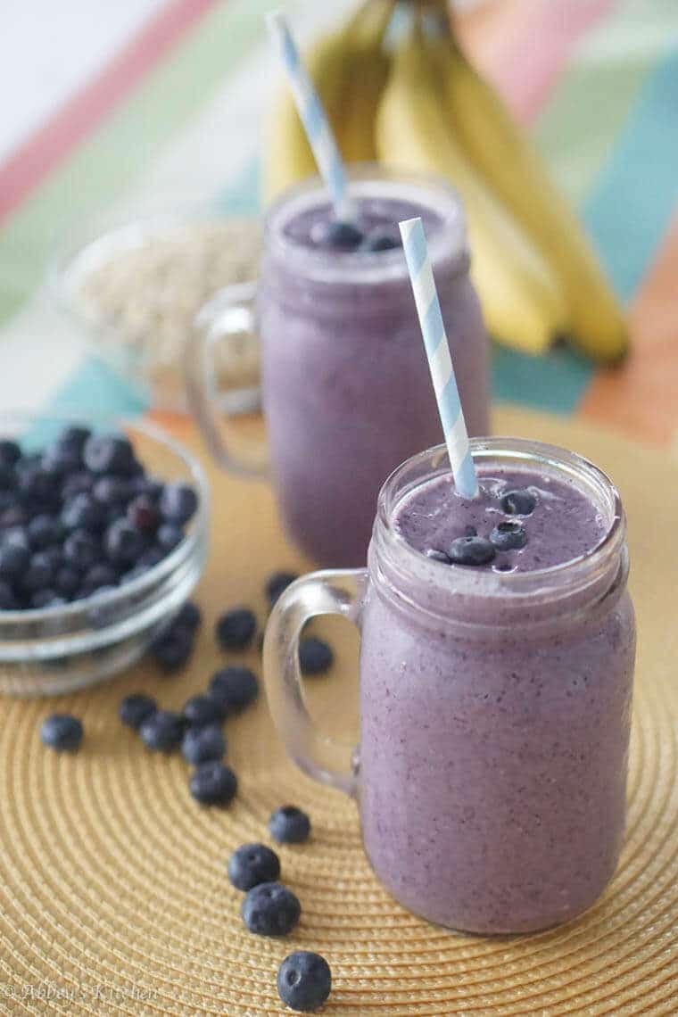 Two glasses of blueberry smoothies.