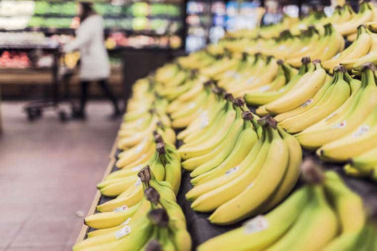 A grocery shelf with bananas.