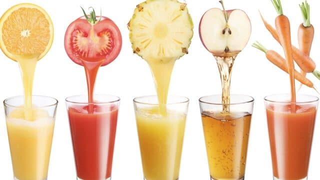 Glasses of juices with the fruit on top.
