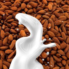 Almonds with milk splashed in front.