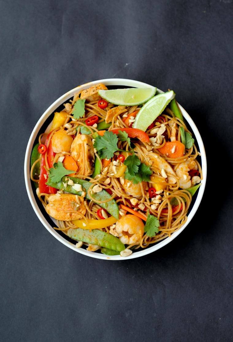 An overhead photo of a bowl of chicken curry noodles.