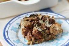 A plate of food on a table, with Sausage and Strata