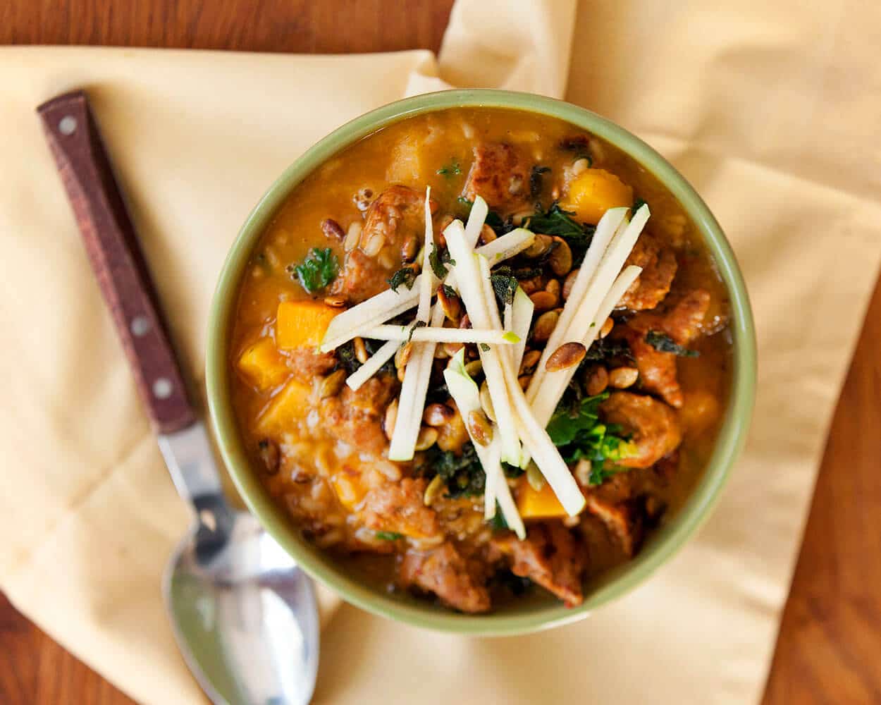 An overhead photo of a bowl of soup with cheese on top.