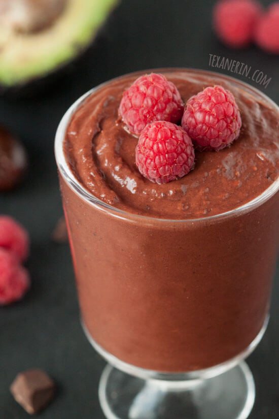 A glass of chocolate raspberry pudding.