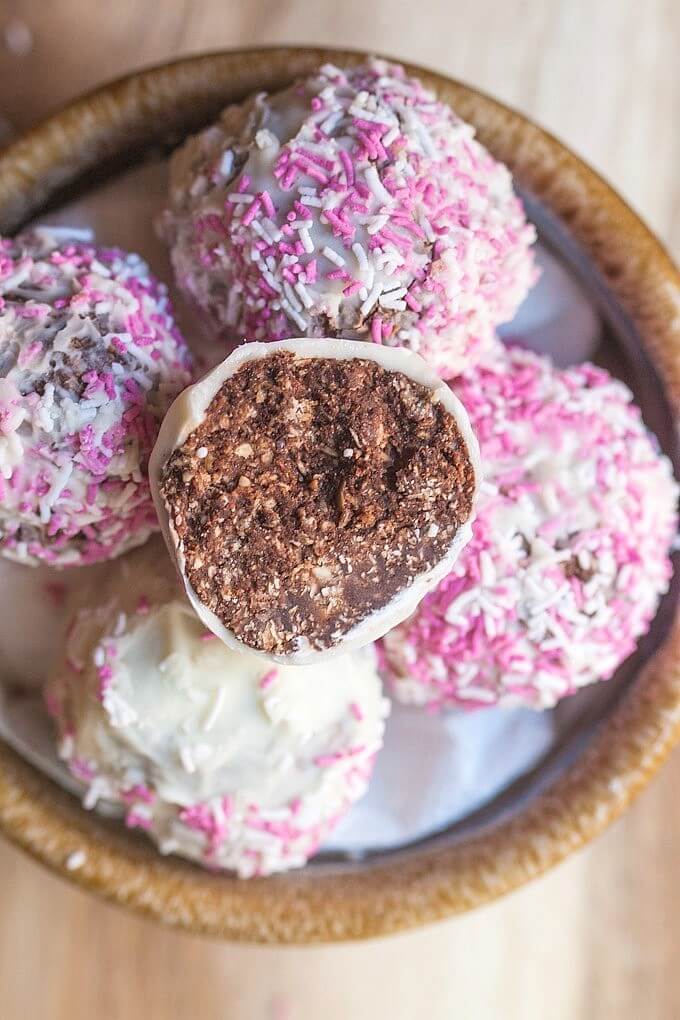 A bowl of chocolate raspberry truffles.