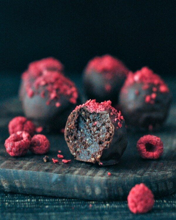 A close raspberry dusted chocolate fudge brownie truffles. 