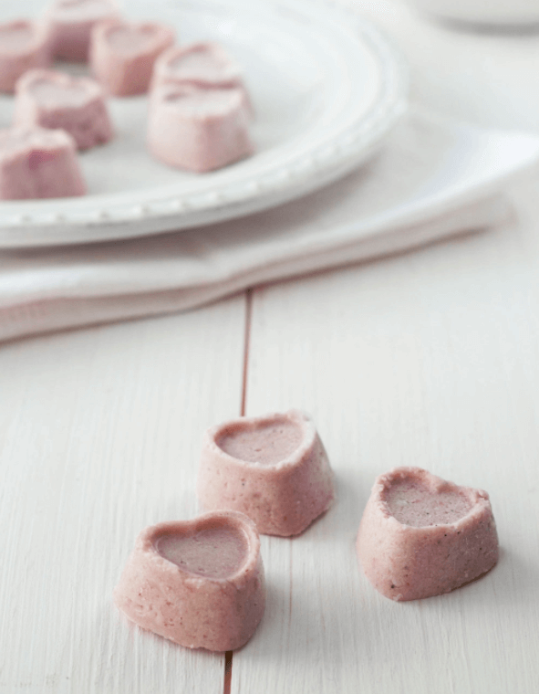 Mini pink heart shaped desserts.