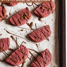 A sheet pan with multiple red velvet shortbread cookies.