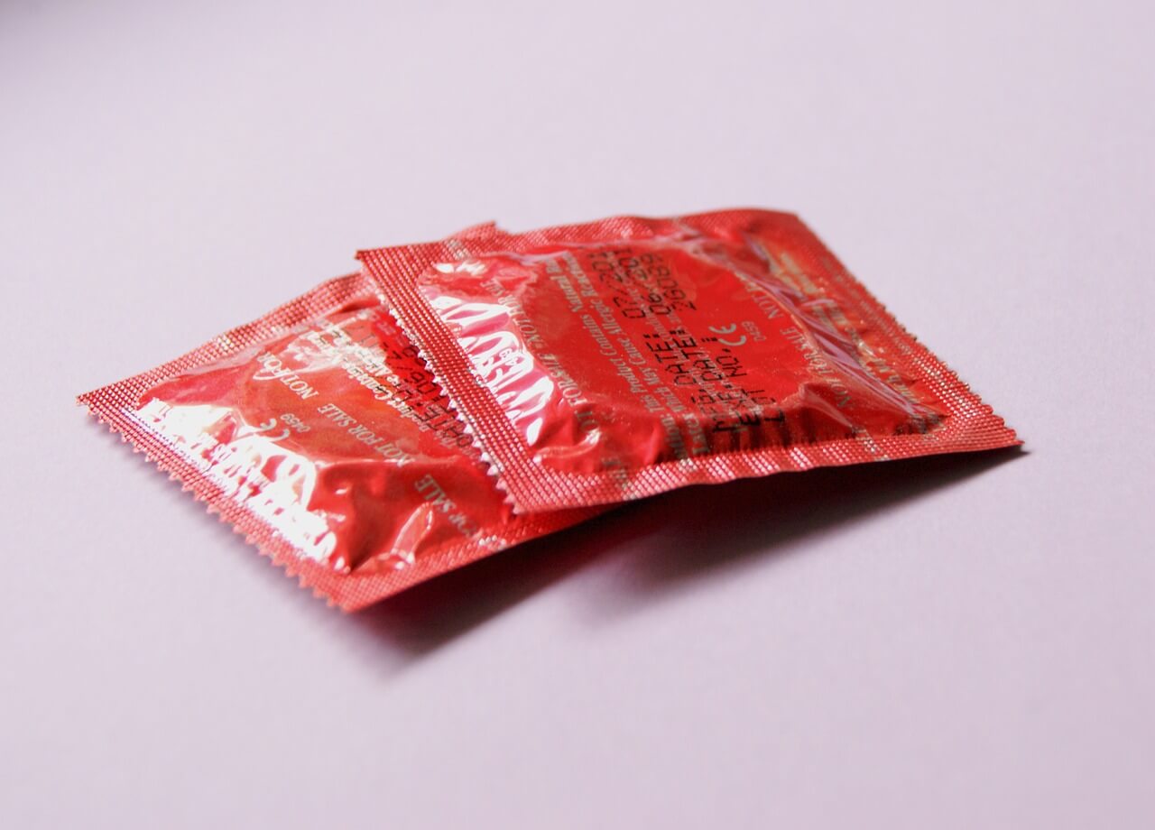 red condoms on a pink table