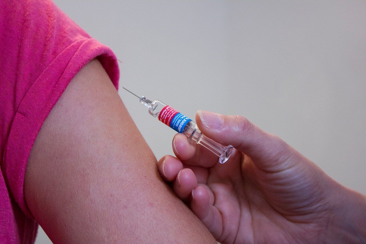 image of a person getting an injection in their arm