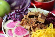 An angled image of a poke bowl with crispy tofu.