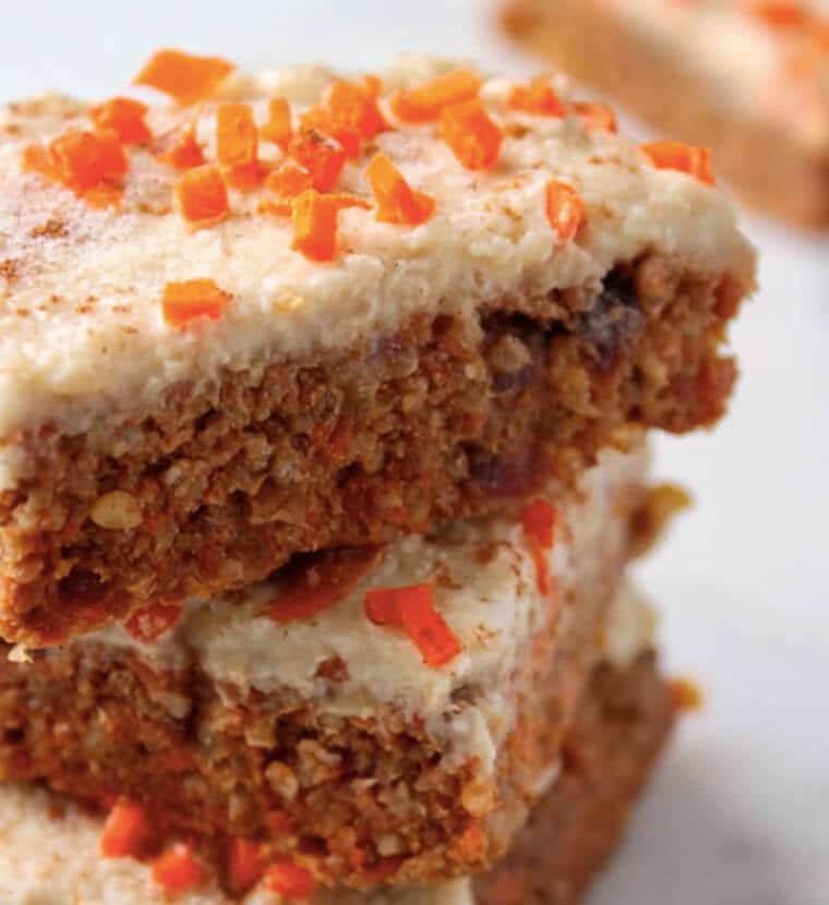 A close up of a stack of carrot cake quinoa bars.