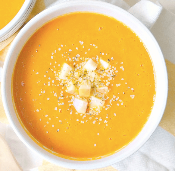 A bowl of carrot autumn squash soup.