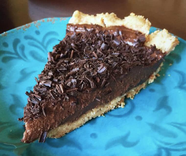 A slice of chocolate silk pie on a plate.