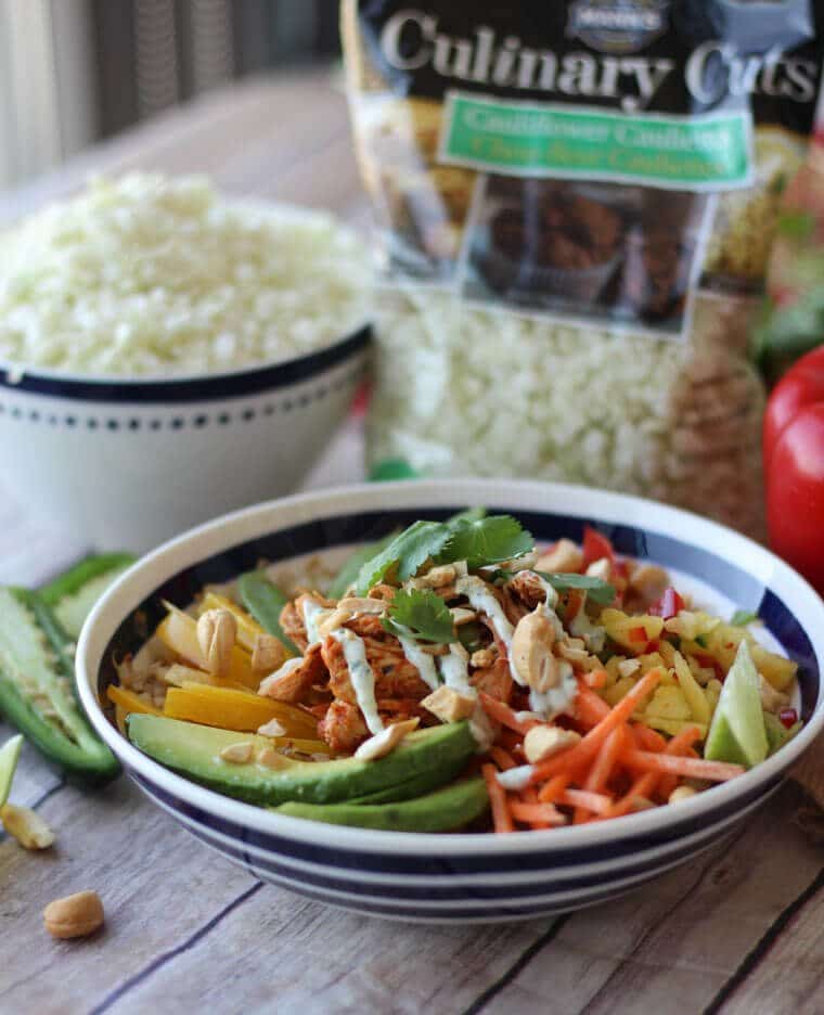 An angled photo of a bowl of paleo cauliflower rice chicken burrito bowl.