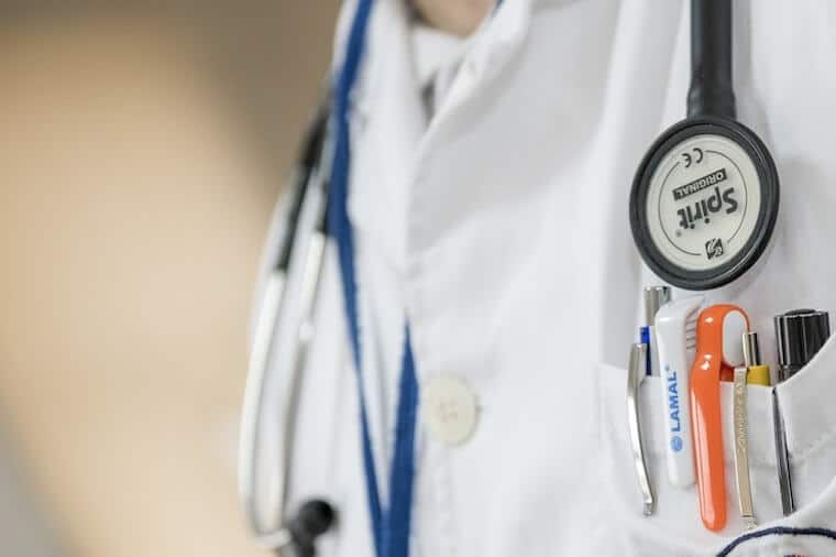 Image of doctor's scrubs and utensils.