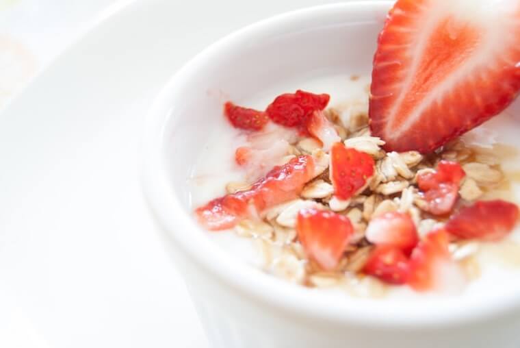 Bowl of oatmeal with strawberries.