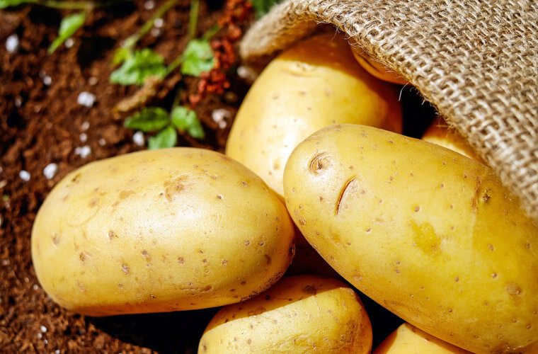 Image of potatoes on a wooden surface