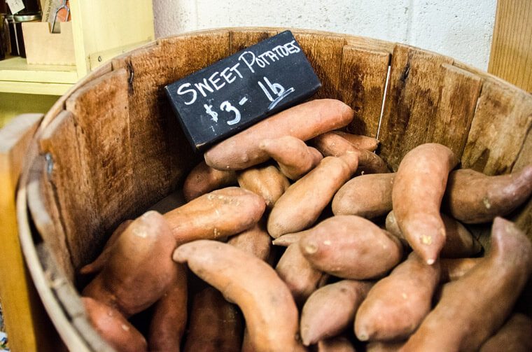 Image of sweet potatoes in a large barrel 