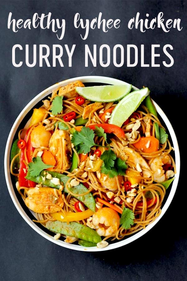 Pinterest image of an overhead image of a bowl of healthy lychee chicken curry noodles with garnish and limes on top with the overlay text \"healthy lychee chicken curry noodles.\"