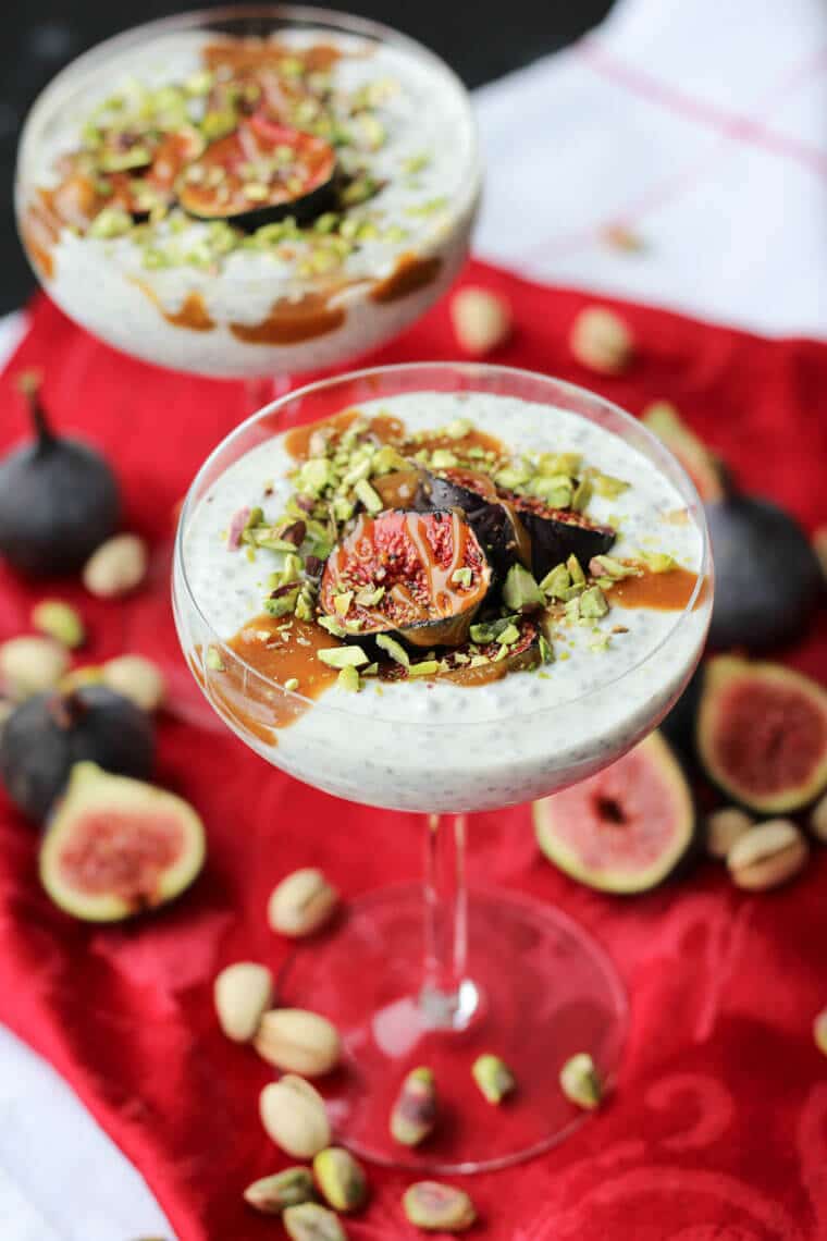 An angled photo of a roasted fig chia pudding with tahini date caramel on top.