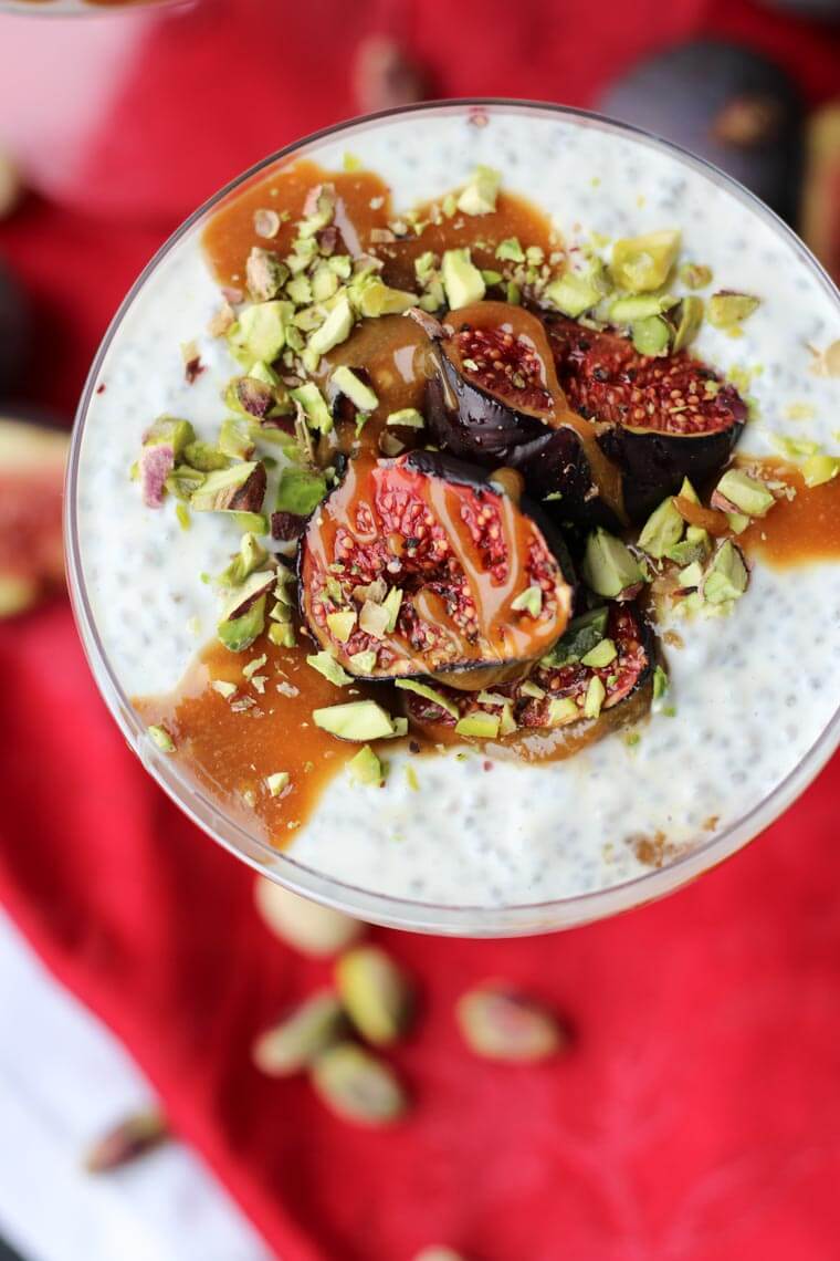 A close up overhead photo of a roasted fig chia pudding with tahini date caramel on top.