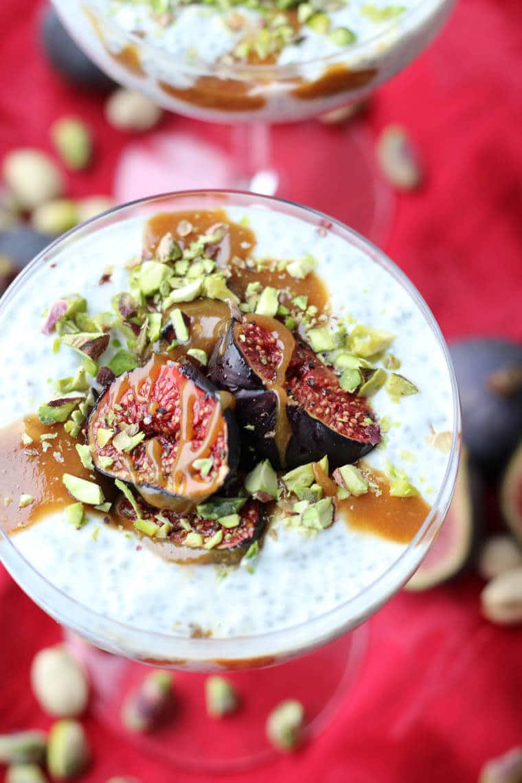 An angled photo of a roasted fig chia pudding with tahini date caramel on top.