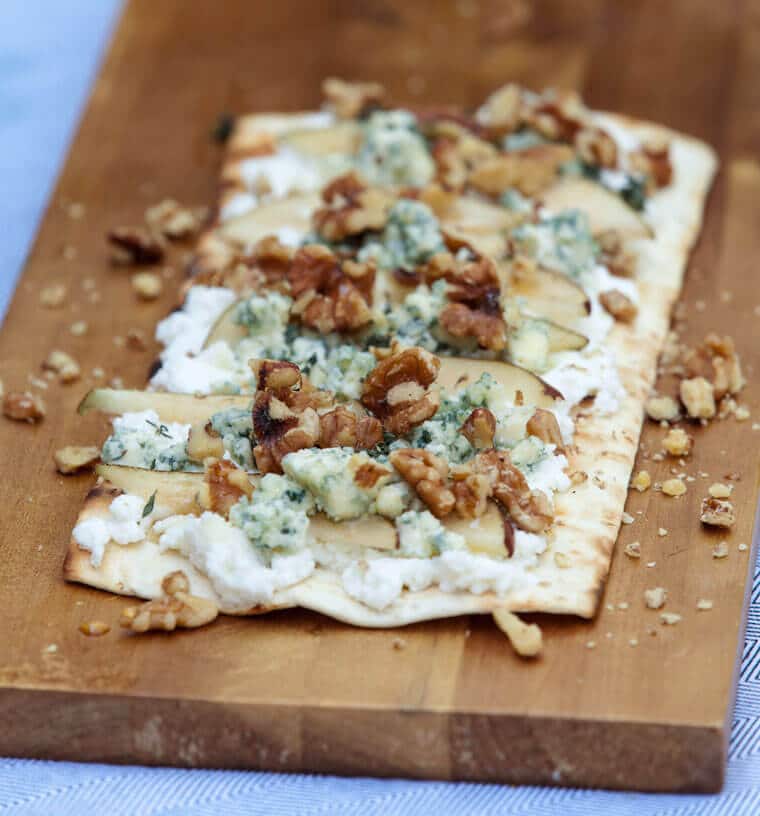 A tasty pear and blue cheese grilled pizza with ricotta, walnuts and thyme.