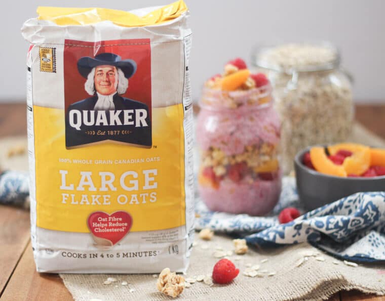 A bag of Quaker large flake oats with a jar of overnight oats in the background.