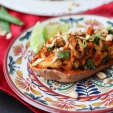 A plate with a stuffed sweet potato peanut satay.