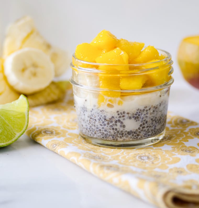 Chia pudding in small mason jar cup topped with chopped mango.