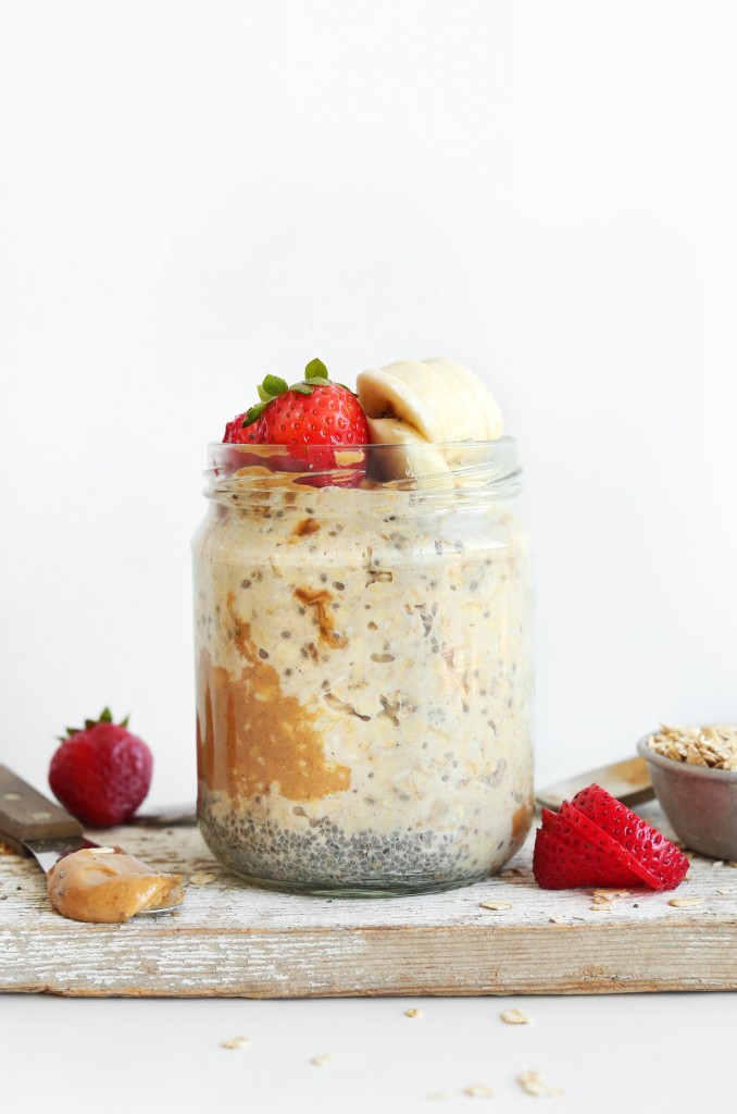 Overnight oats in a glass jar, topped with peanut butter, bananas and strawberries. 