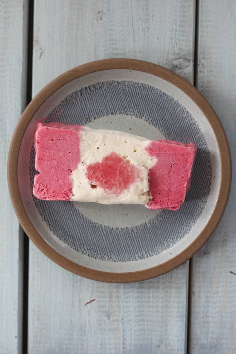 A slice of ice cream cake on a plate.