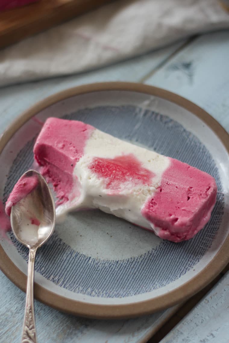 A plate of ice cream cake being eaten.