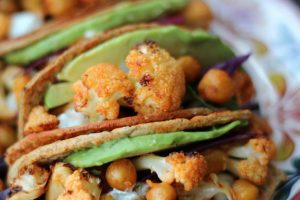 These vegan buffalo cauliflower and chickpea hard tacos are loaded with spicy buffalo flavour in buffalo-glazed hard tacos.