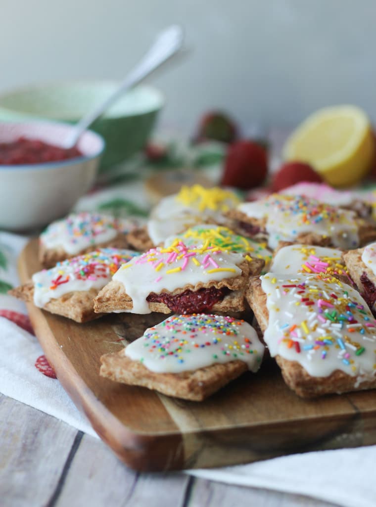 Homemade pop tarts on a wooden board.