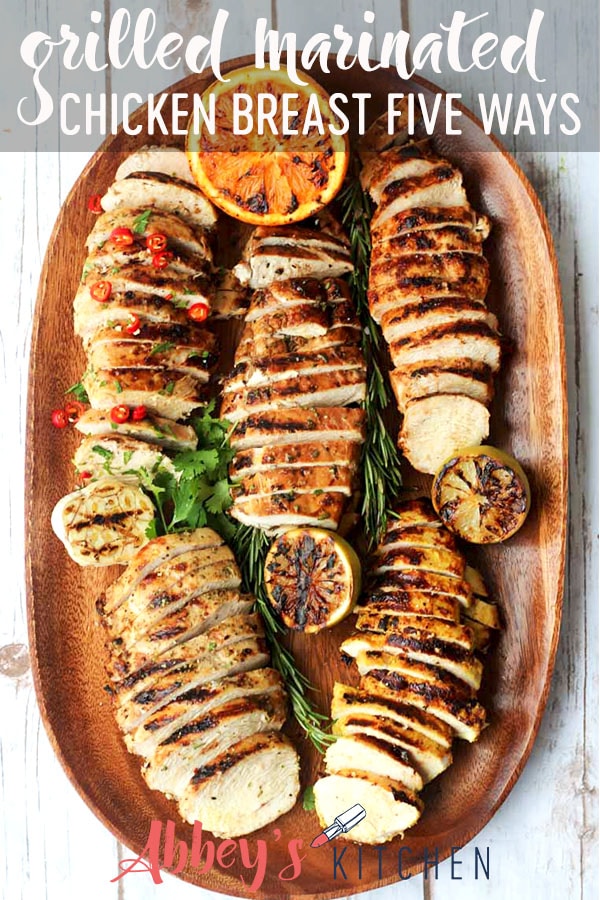 pinterest image of grilled marinated chicken breasts five ways on a wooden serving board with text overlay