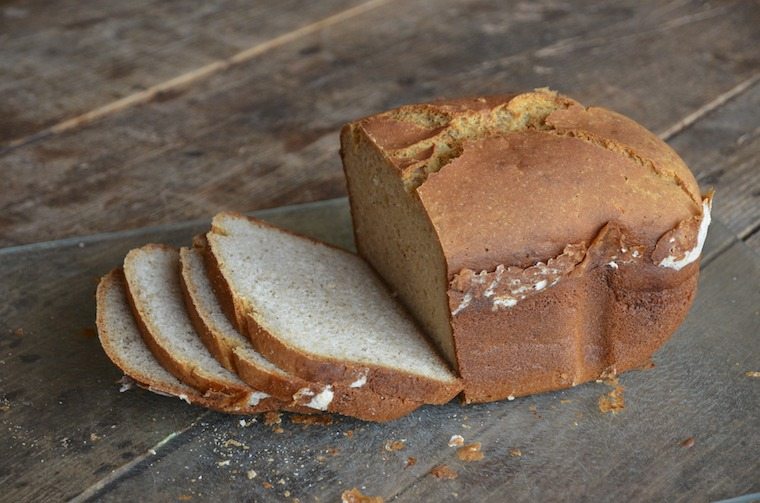 A loaf of bread being sliced.