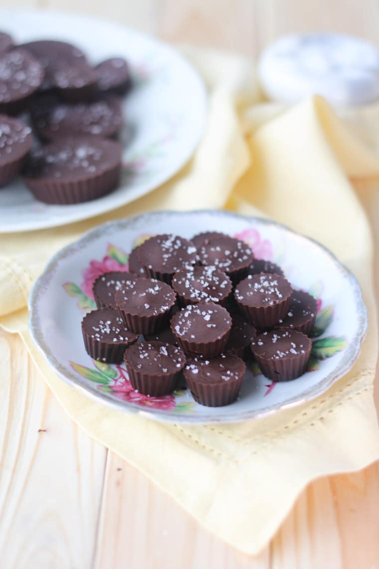 floral plate containing vegan chocolate caramel cups topped with flaky salt