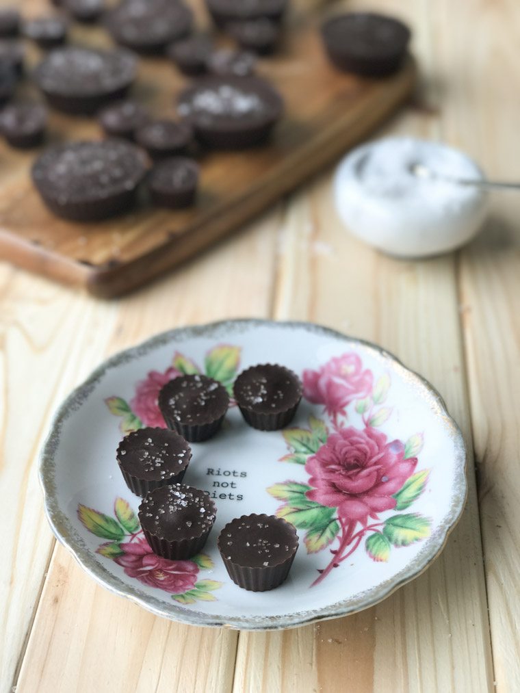 vegan gluten free tahini caramel chocolate cups on a floral plate