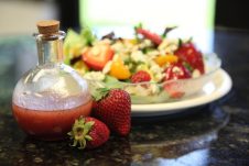 A plate of salad on a table.