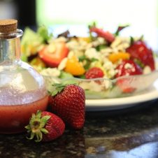 A plate of salad on a table.