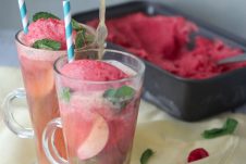 Two glasses of kombucha floats with ice cream in the background.