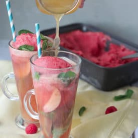 Two glasses of kombucha floats with ice cream in the background.