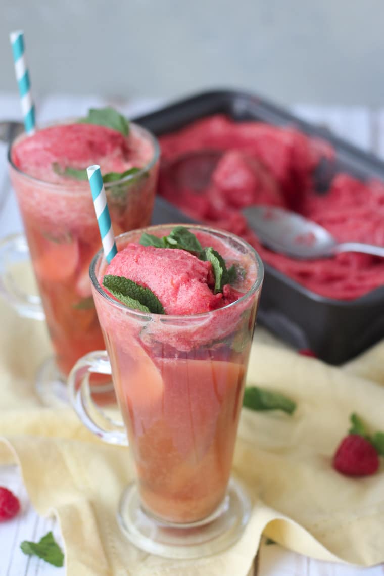 Two glasses of kombucha floats with ice cream in the background.