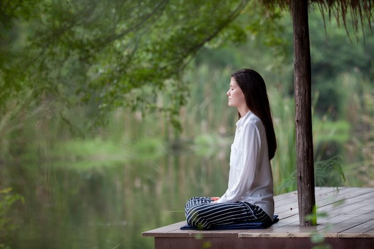 person meditating outside